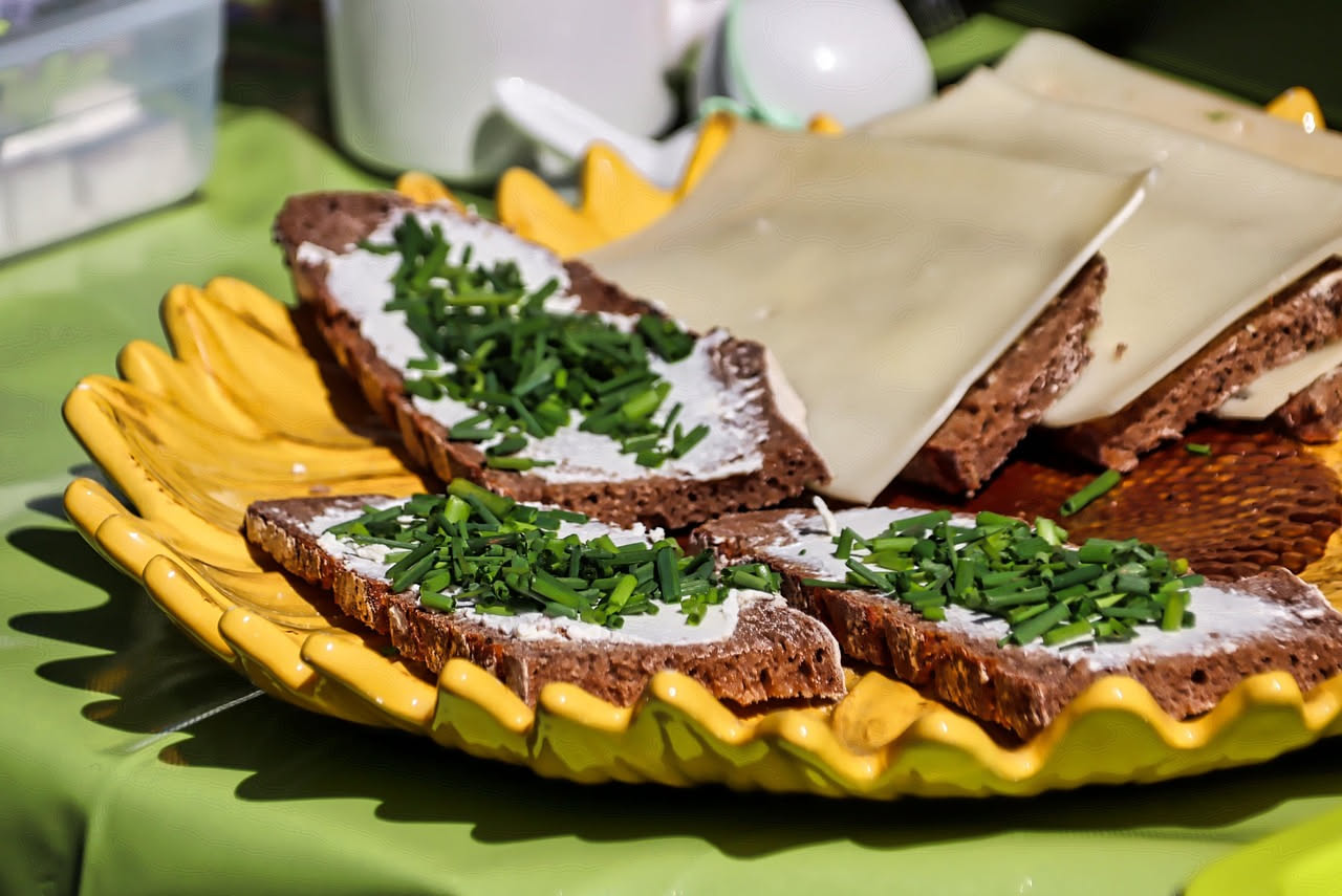 Crostini di fegatelli su un piatto bianco, con il ripieno marrone scuro ben distribuito sul pane tostato, completati con una basata di rosmarino fresco