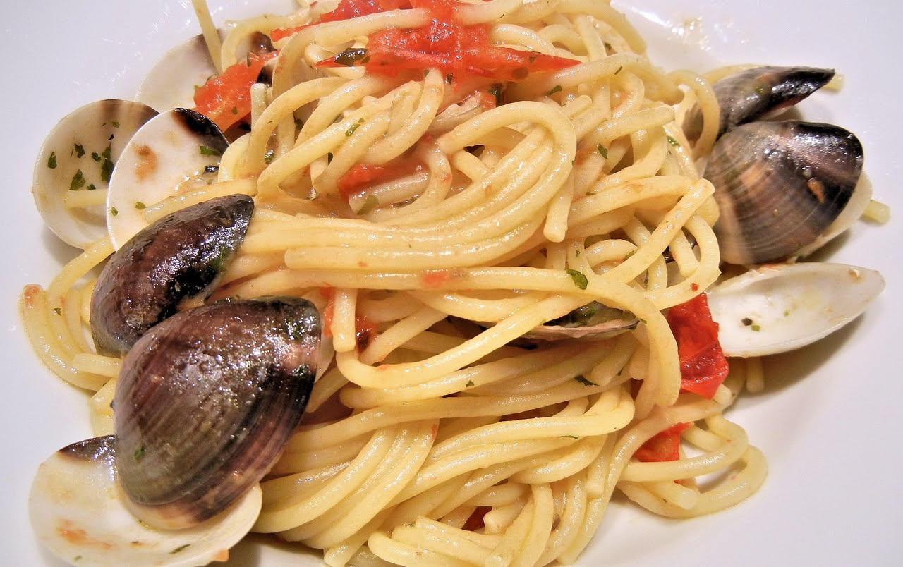 Pistoccu spezzato su un tavolo di legno, pane toscano piatto dorato croccante con cristalli di sale grosso in rilievo sulla superficie